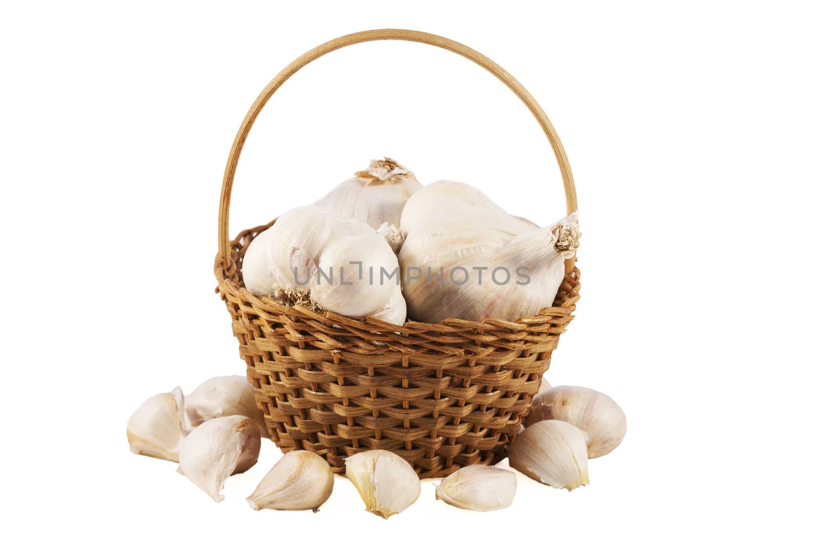 Garlics in a basket over white isolated background