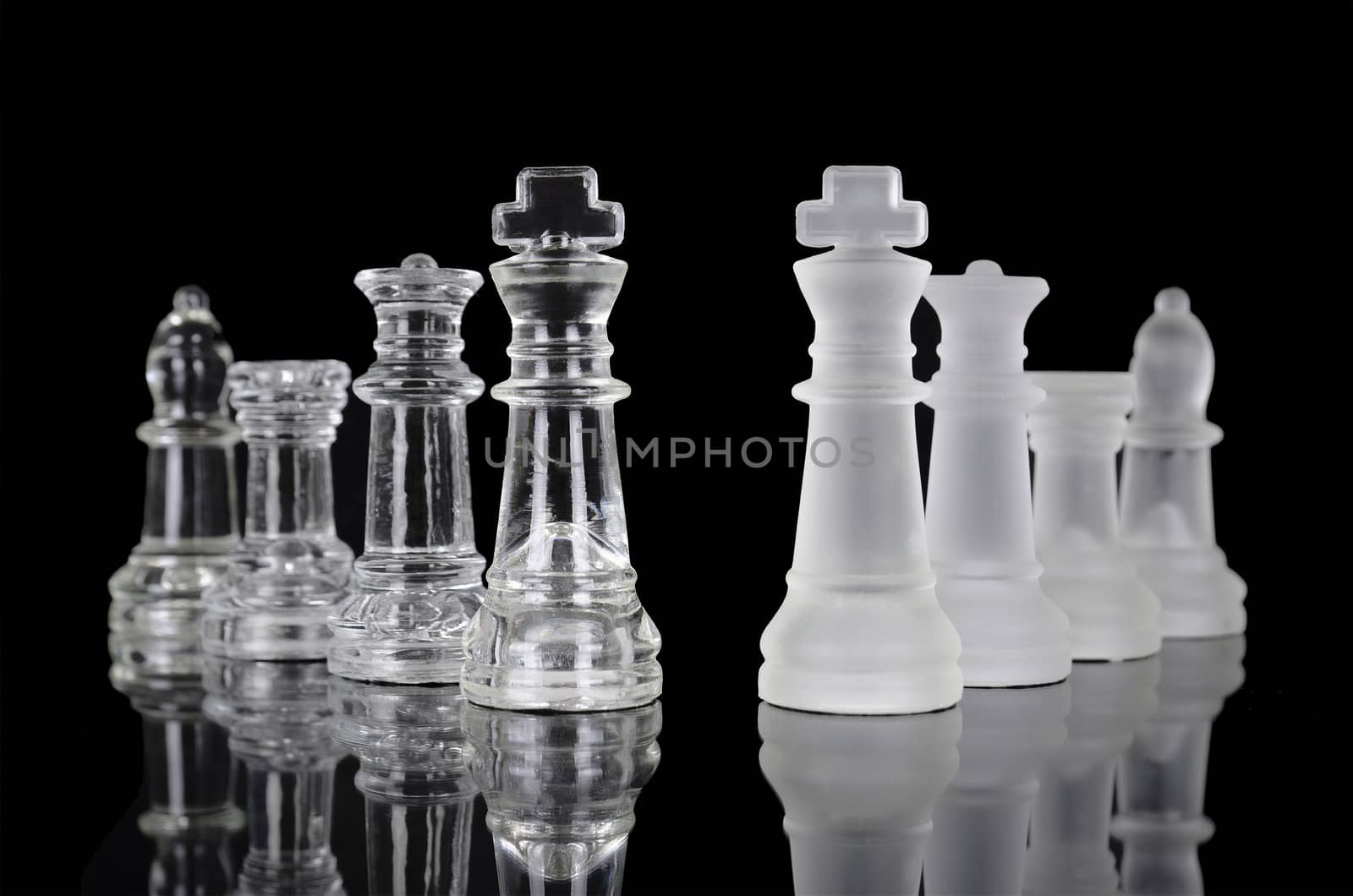 Chess pieces isolated on black background. Beautiful reflection composition by HERRAEZ