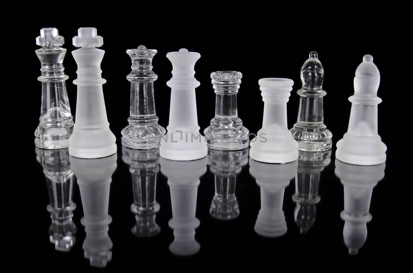 Chess pieces isolated on black background. Beautiful reflection composition by HERRAEZ