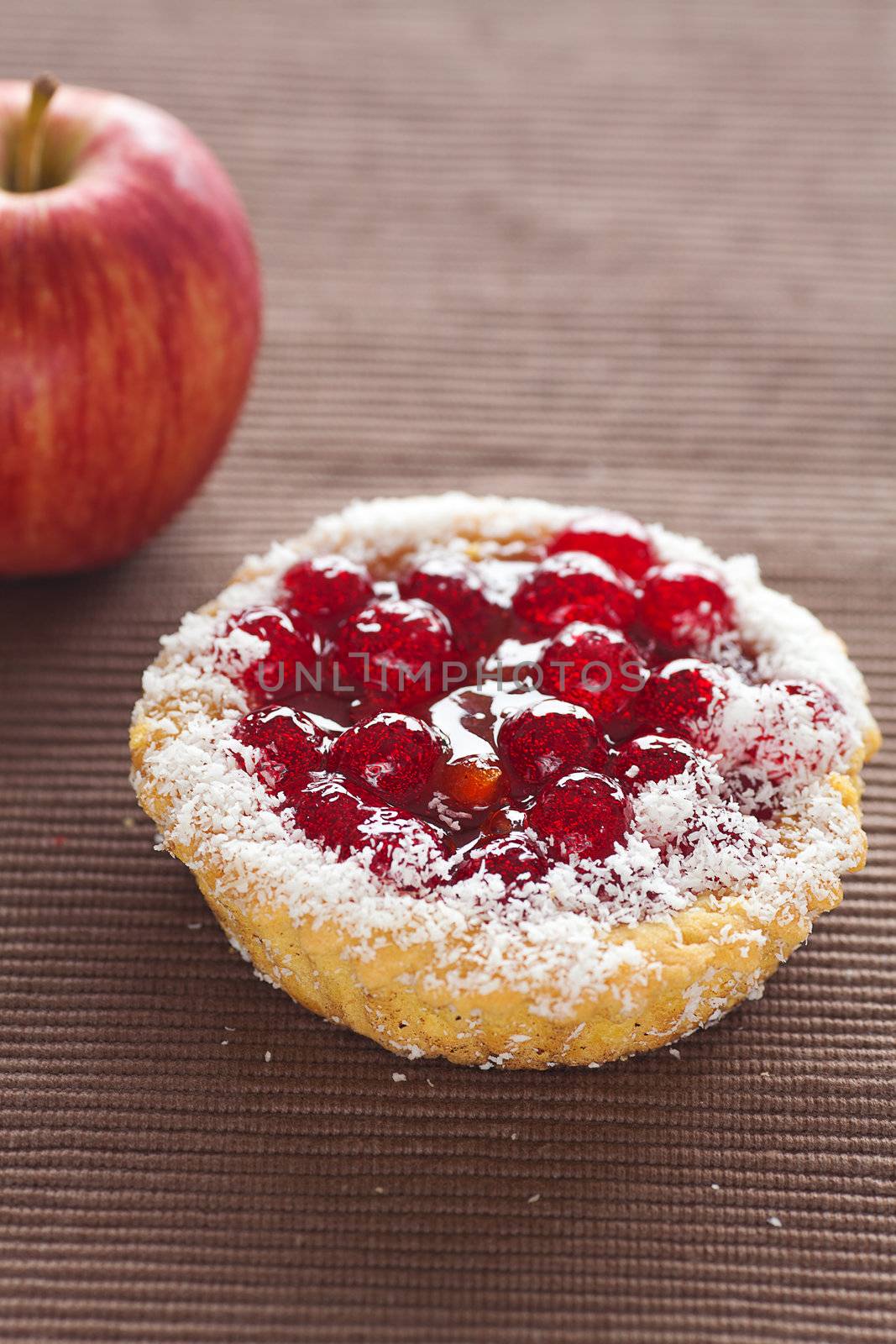 beautiful cake with berries and apple on brown mat