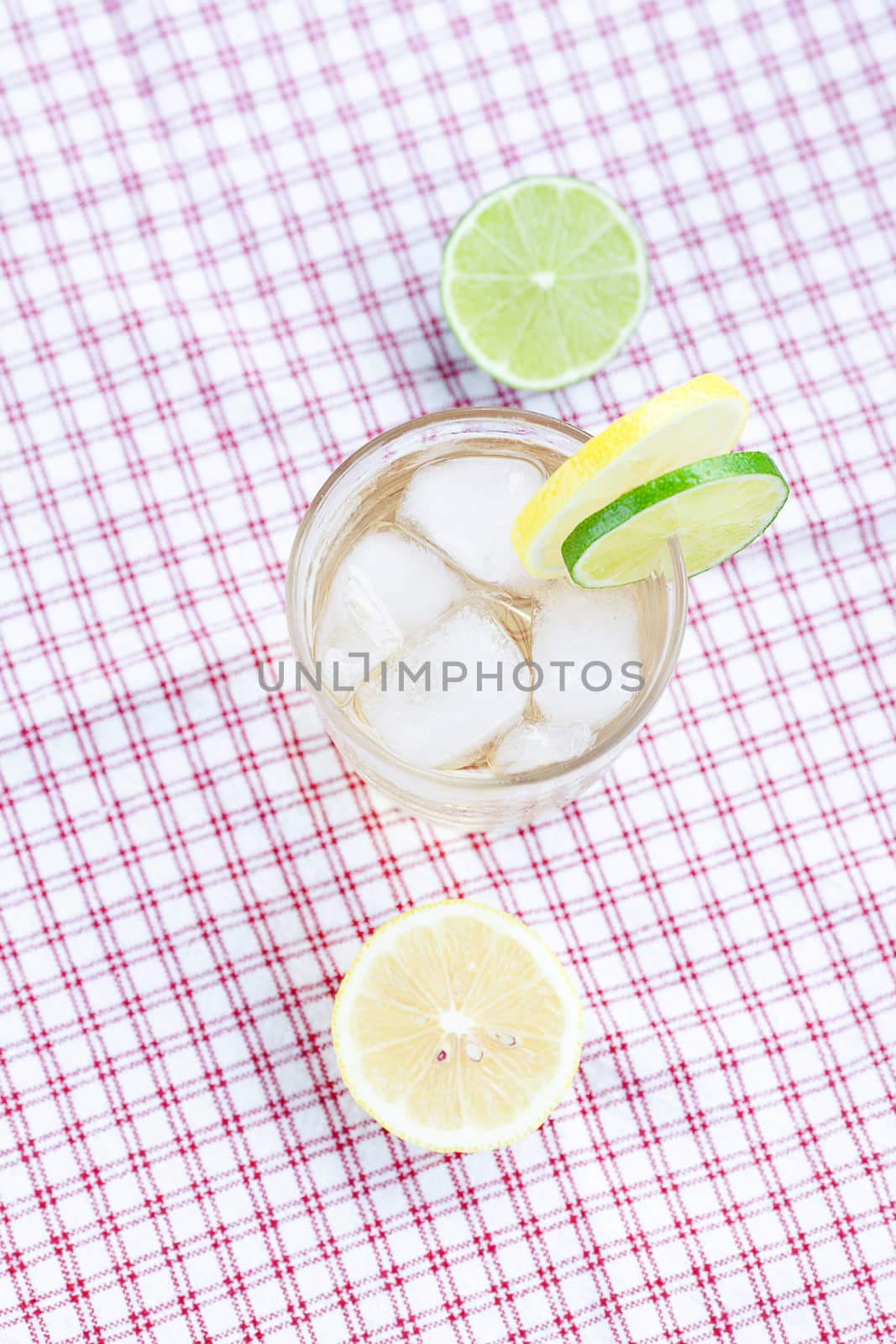 water with lemon and lime in a glass with ice