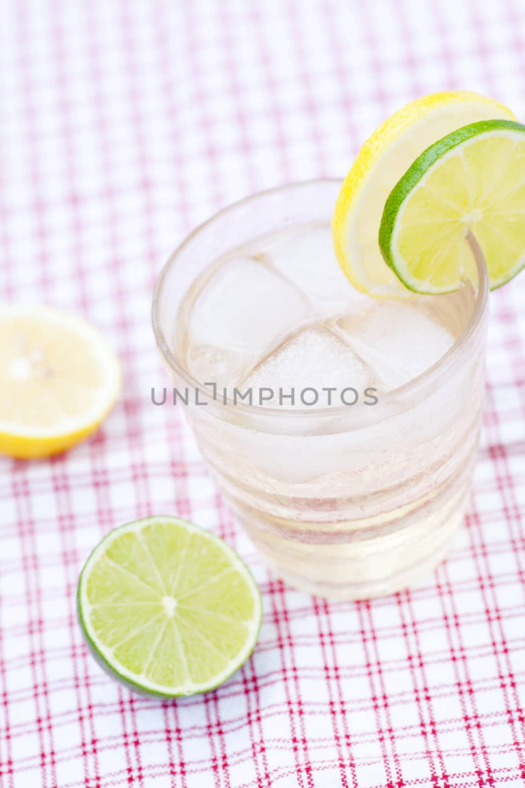 water with lemon and lime in a glass with ice