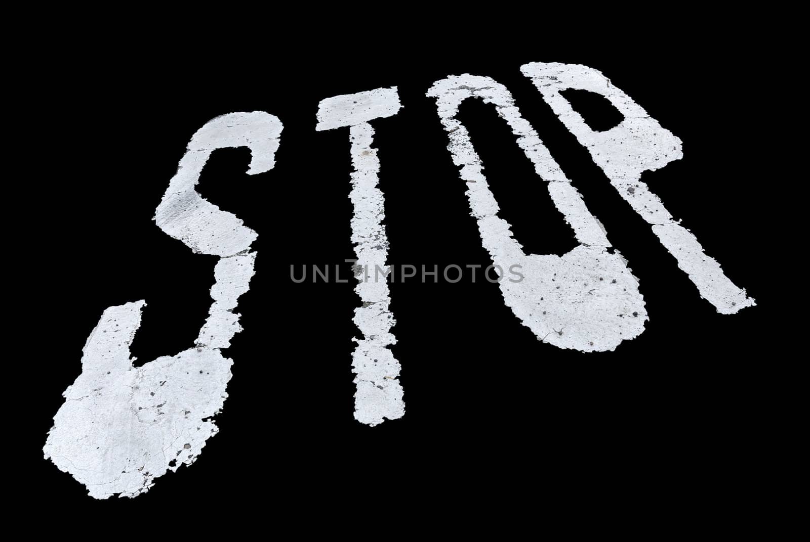 Stop sign painted on the wall isolated over black background