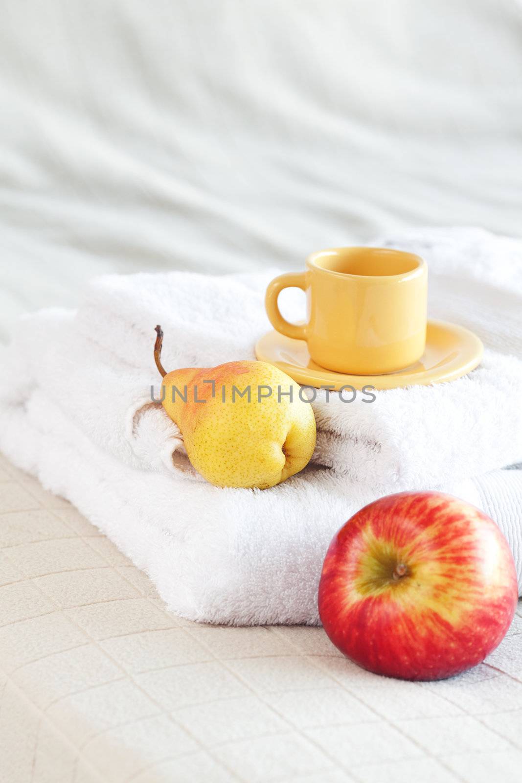 cup of tea,apple and pear on the bed