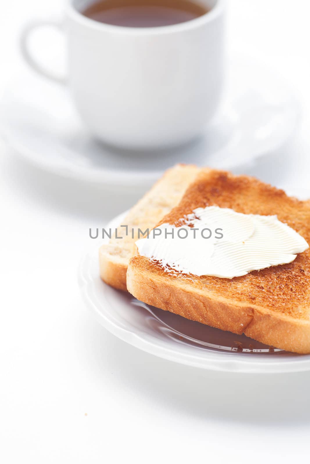 tea and toast with butter isolated on white by jannyjus
