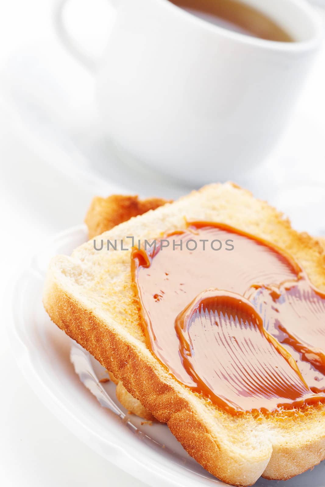 tea and toast with caramel isolated on white