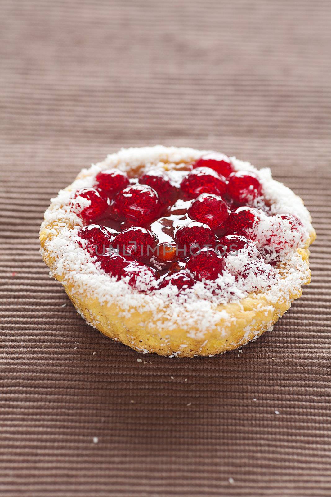 beautiful cake with berries on brown mat