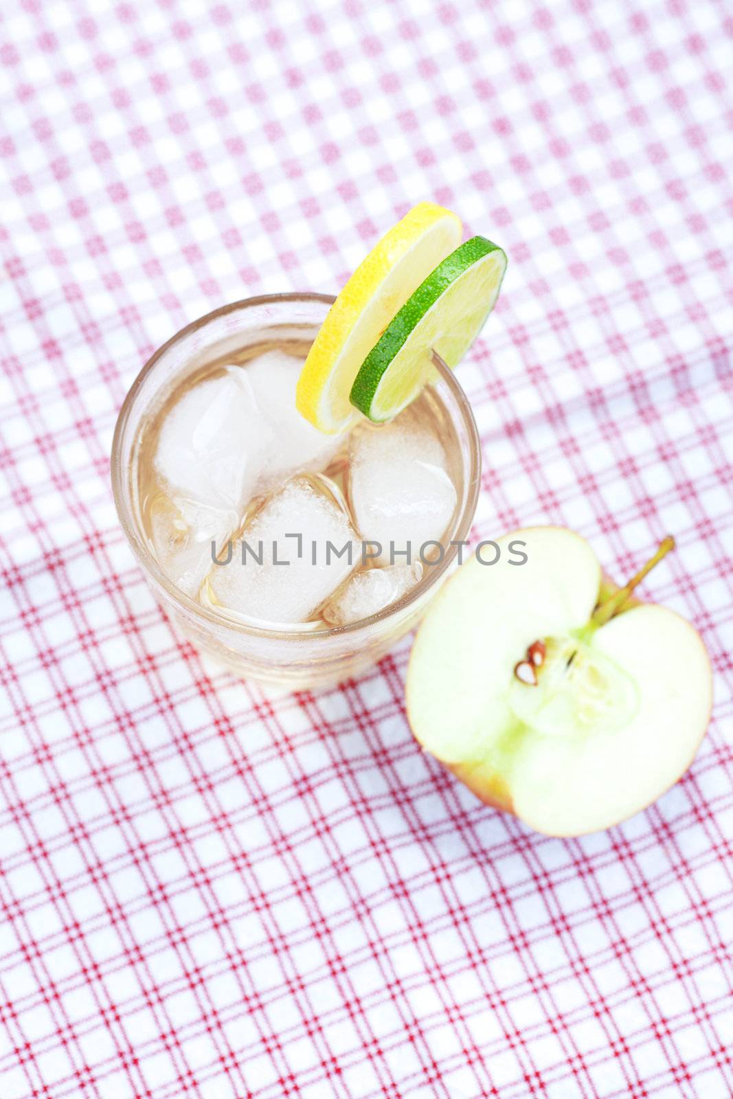 water with lemon and lime,apple in a glass with ice