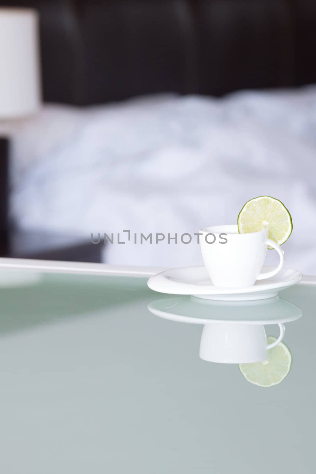 tea with lemon on the background of the bed and the lamp by jannyjus