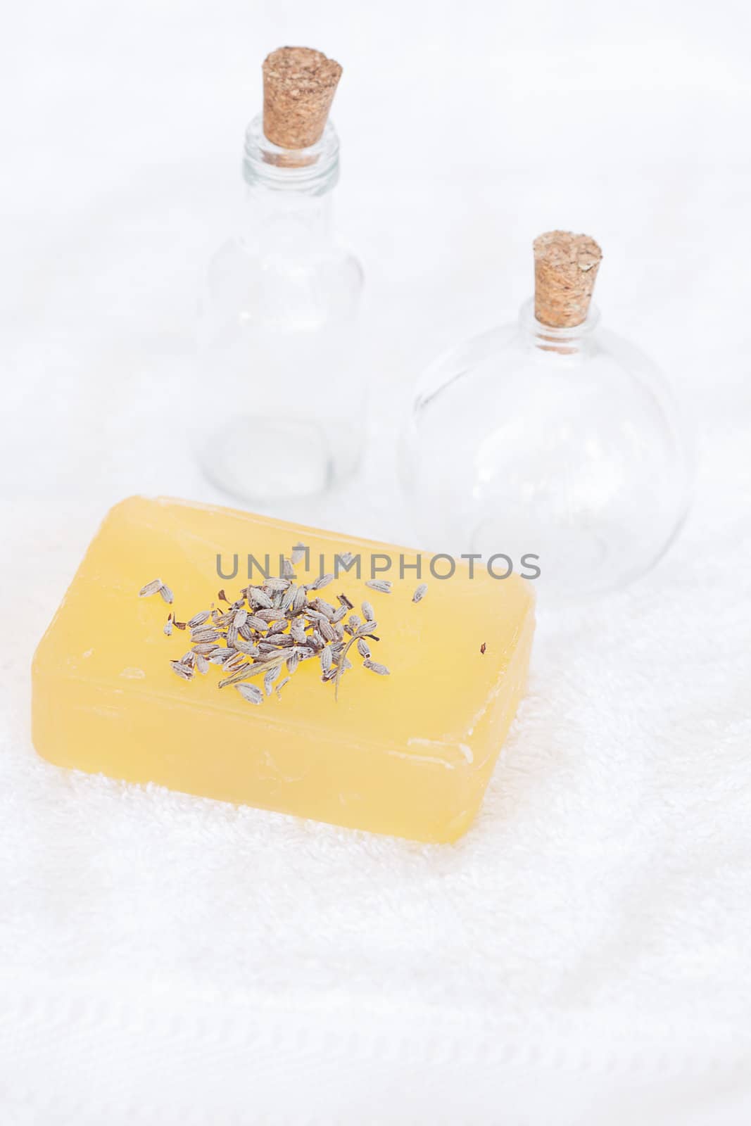 bottles, soap and lavender on a white towel