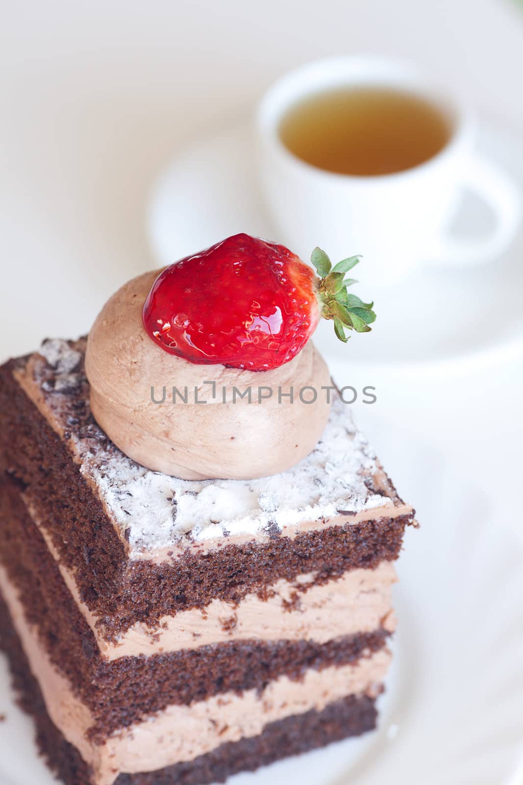 beautiful cake with strawberry and tea on a white background