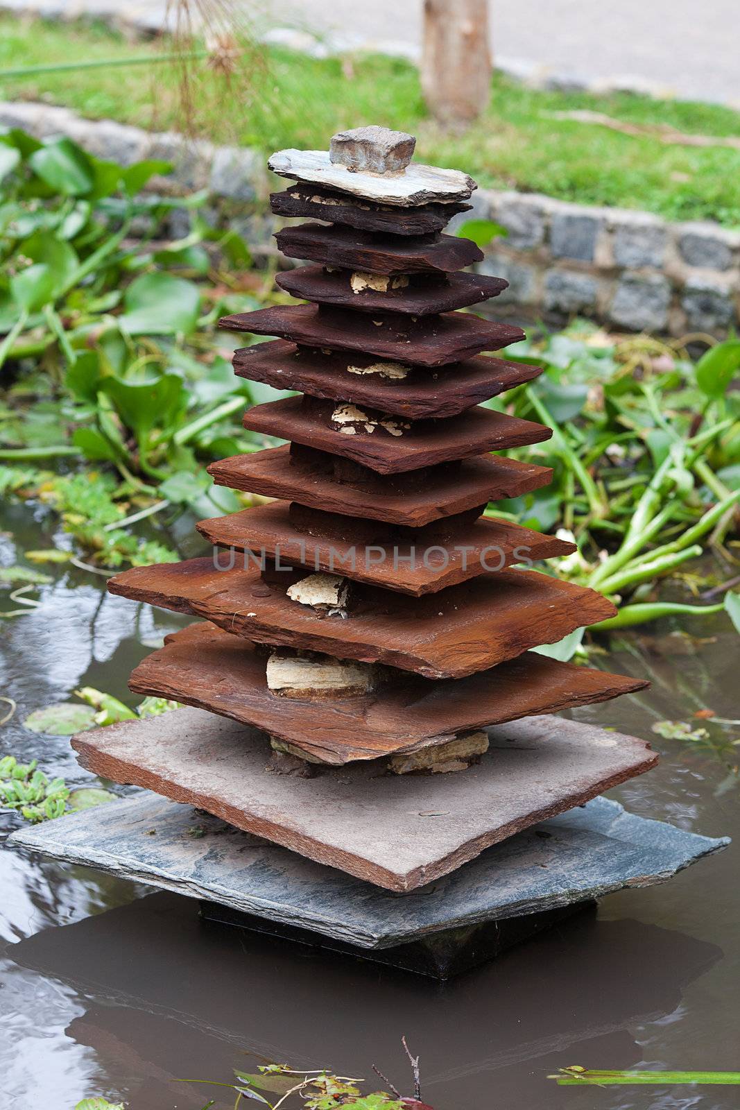 Japanese wooden pagoda in the background of green grass by jannyjus