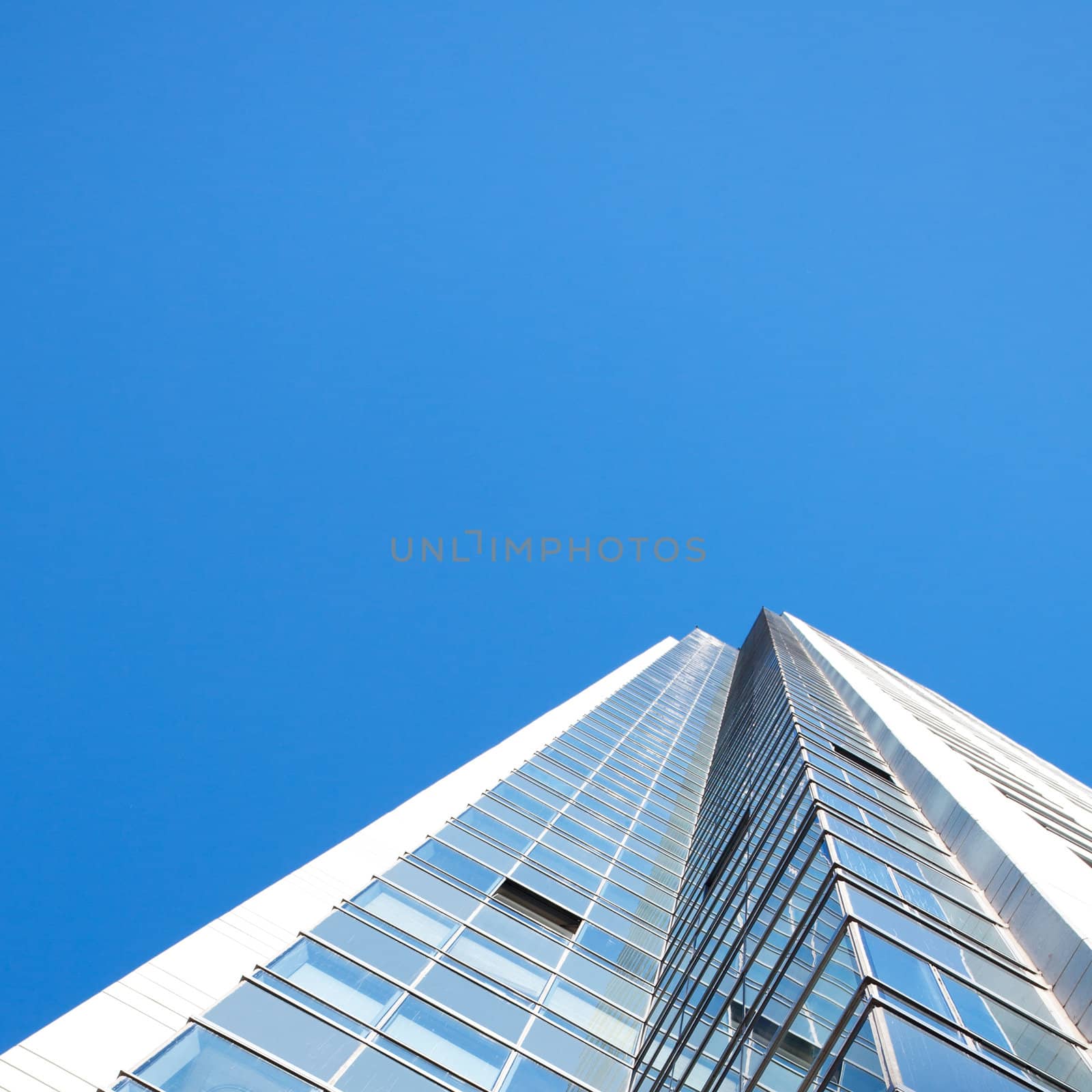 Beautiful modern office building against the blue sky by jannyjus