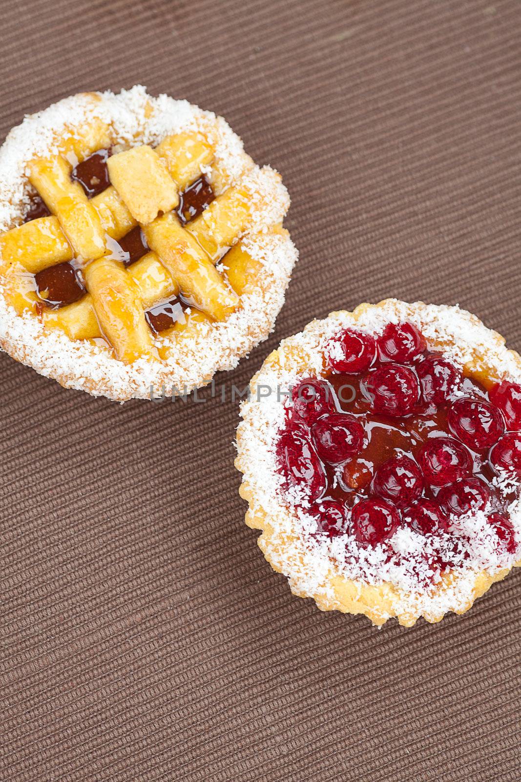 beautiful cake with berries on brown mat by jannyjus