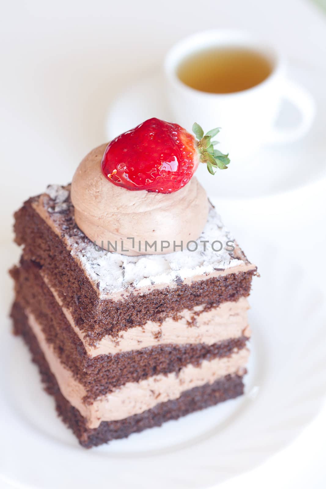 beautiful cake with strawberry and tea on a white background