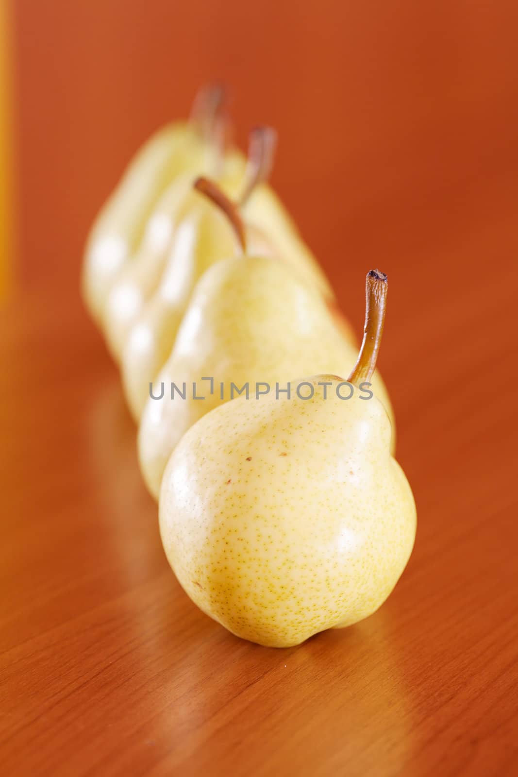 pears lying on a wooden table