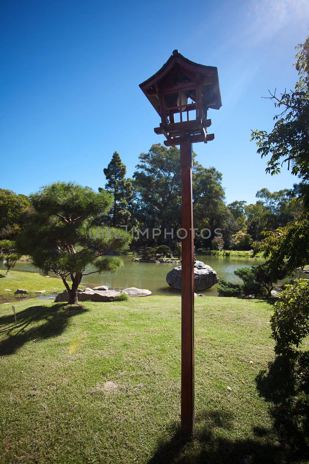 Japanese lantern on a background of blue sky  by jannyjus