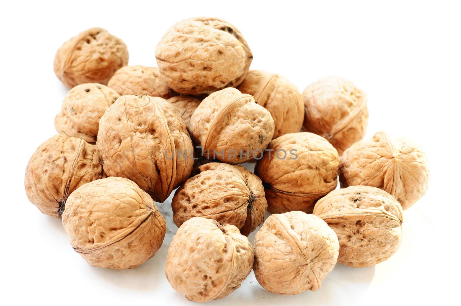 A pile of walnuts on a white background