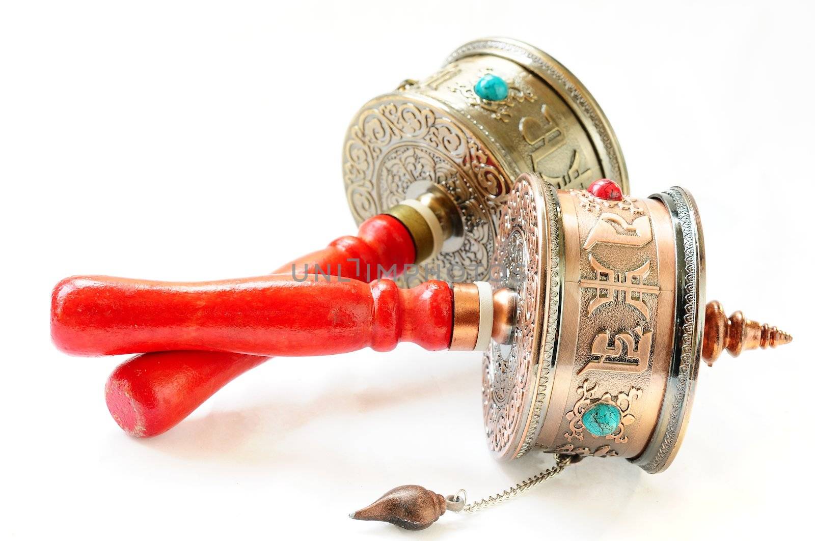 Tibetan prayer wheels on a white background