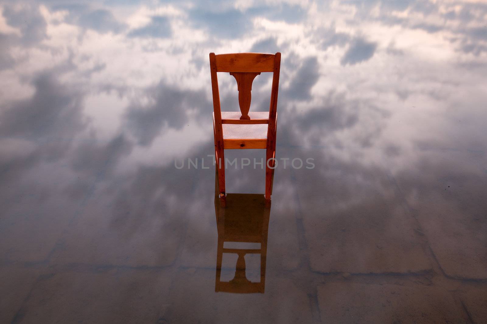 The old chair in the lake at sunset