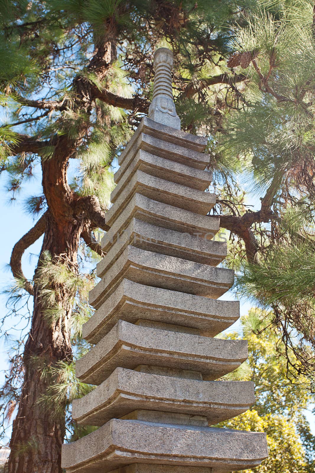 stone pagoda on the background of green trees