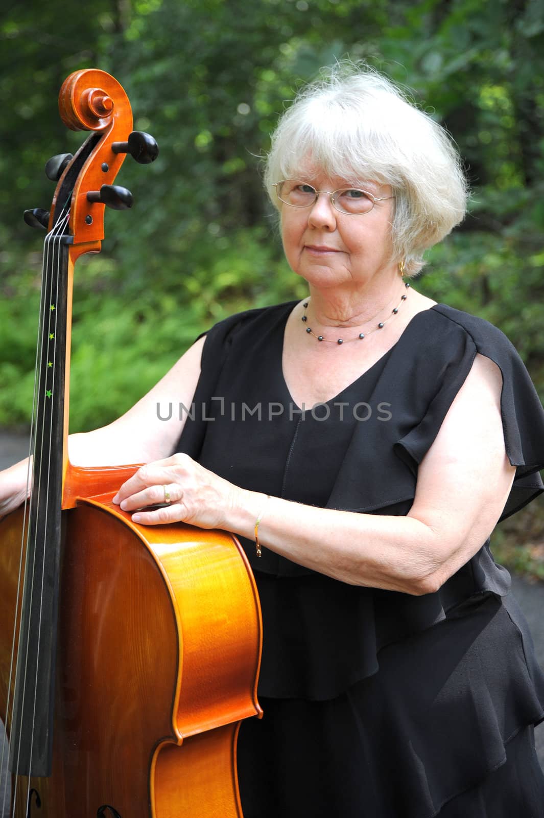 Female cellist standing with her cello.