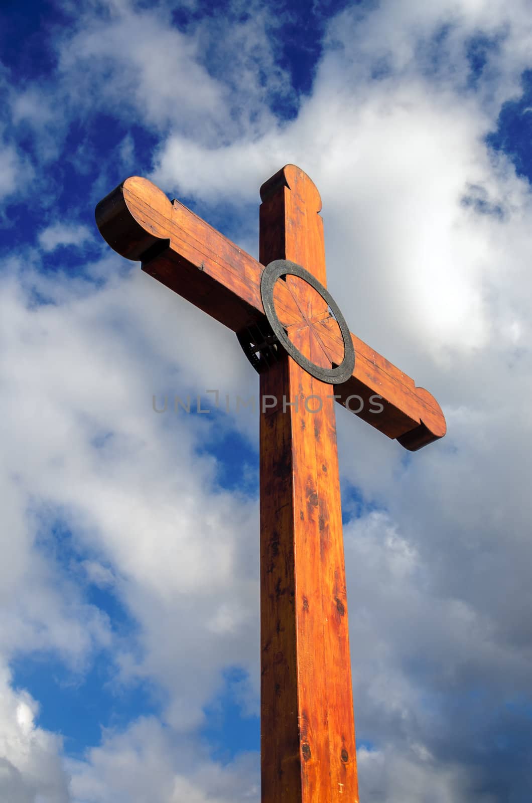 Looking up at a wooden cross and a beautiful blue sky