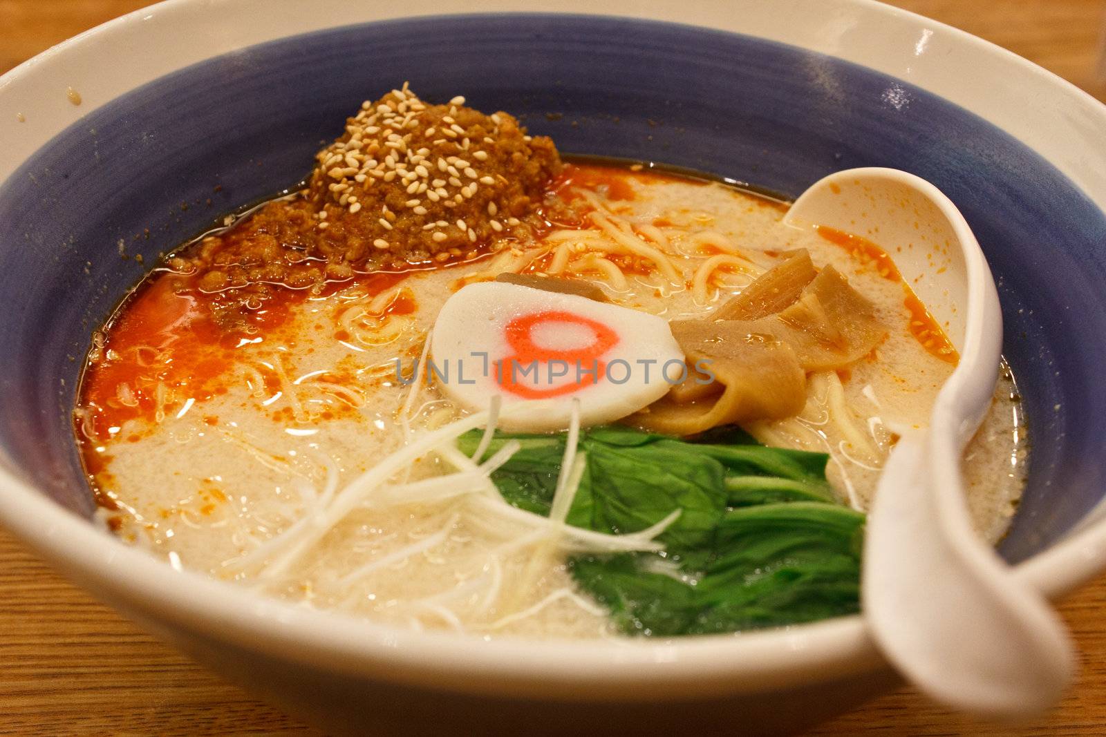 pork bone soup noodle with spicy ground pork garnished with Japanese spring onion, pak choi, kamaboko, sesame seeds and memma