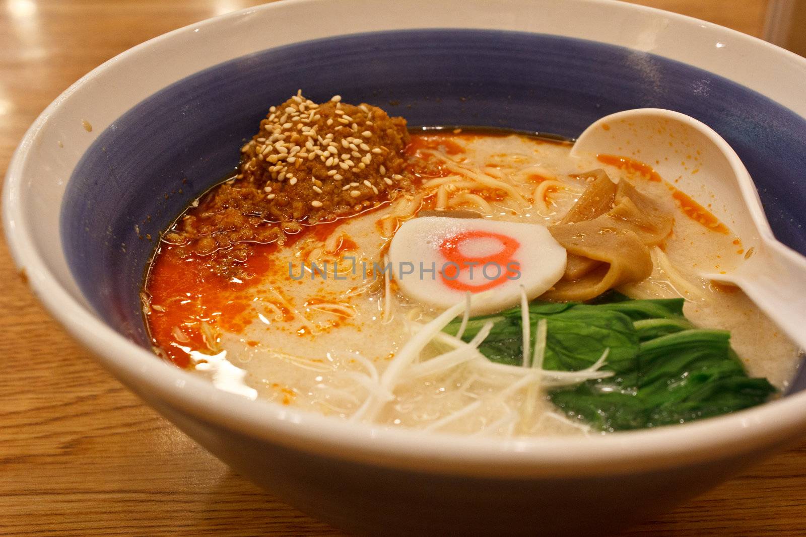 pork bone soup noodle with spicy ground pork garnished with Japanese spring onion, pak choi, kamaboko, sesame seeds and memma