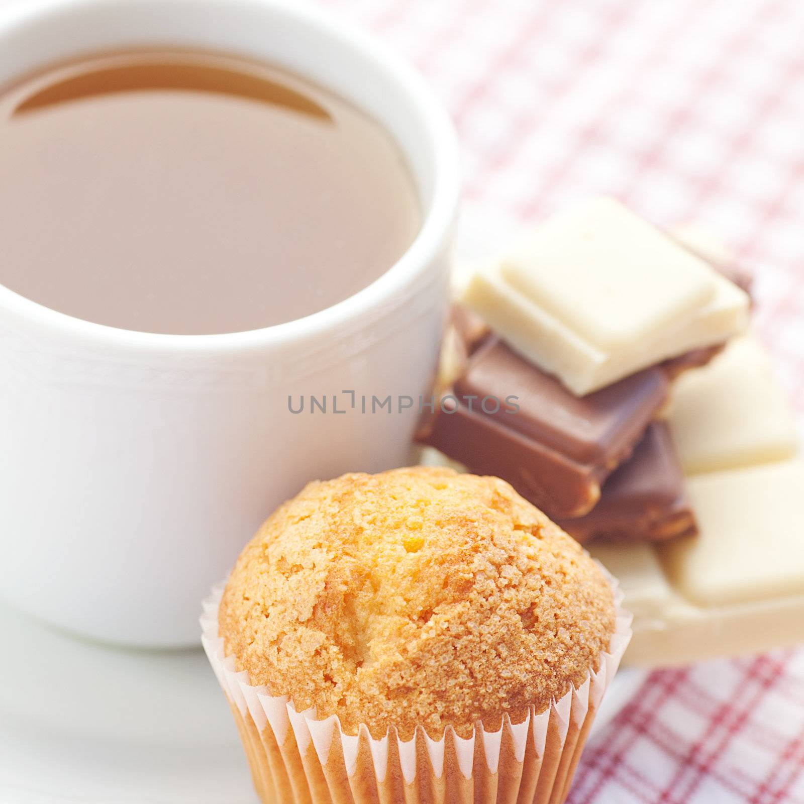 bar of chocolate,tea and muffin on plaid fabric by jannyjus