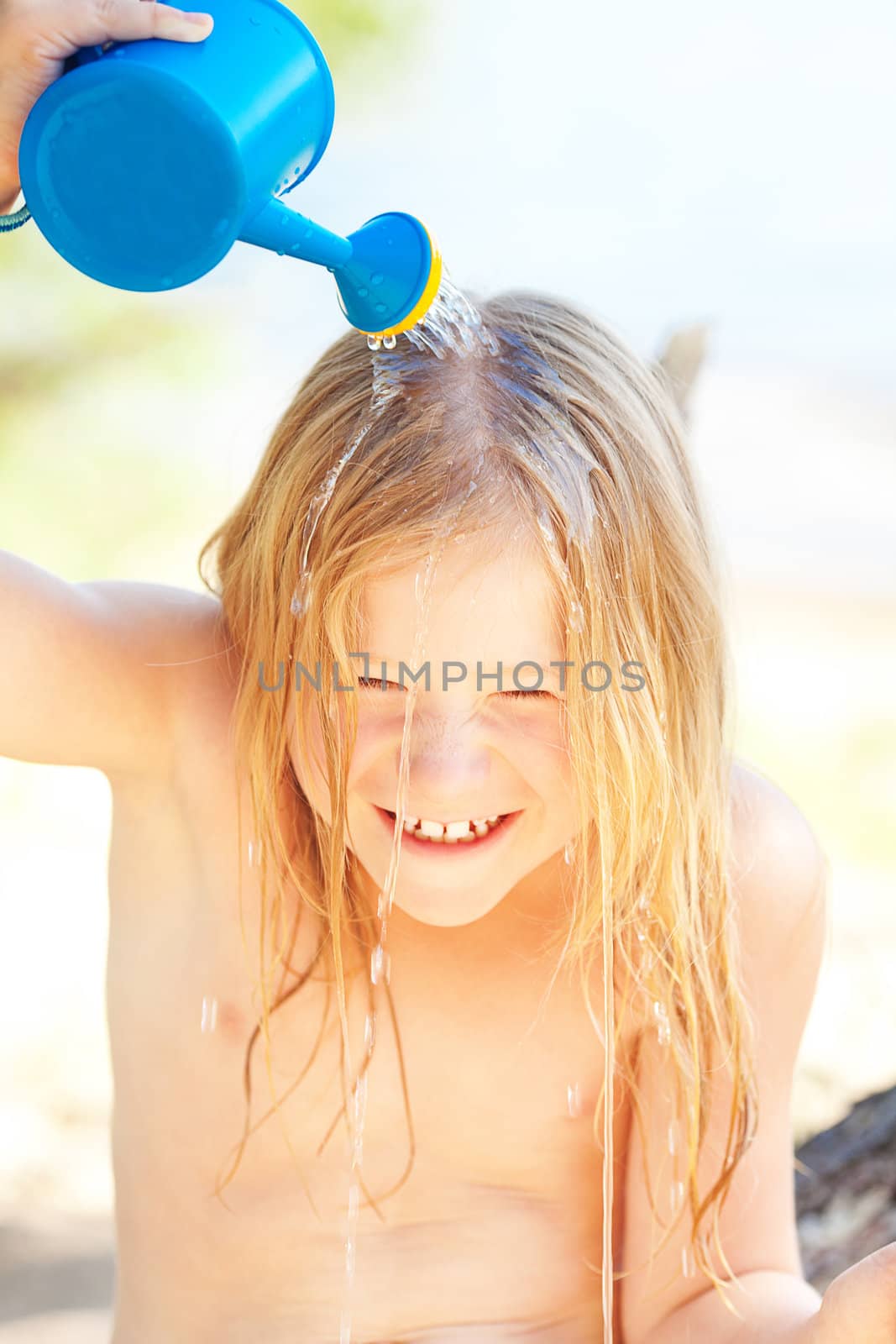 portrait of a beautiful little girl with a watering can by jannyjus