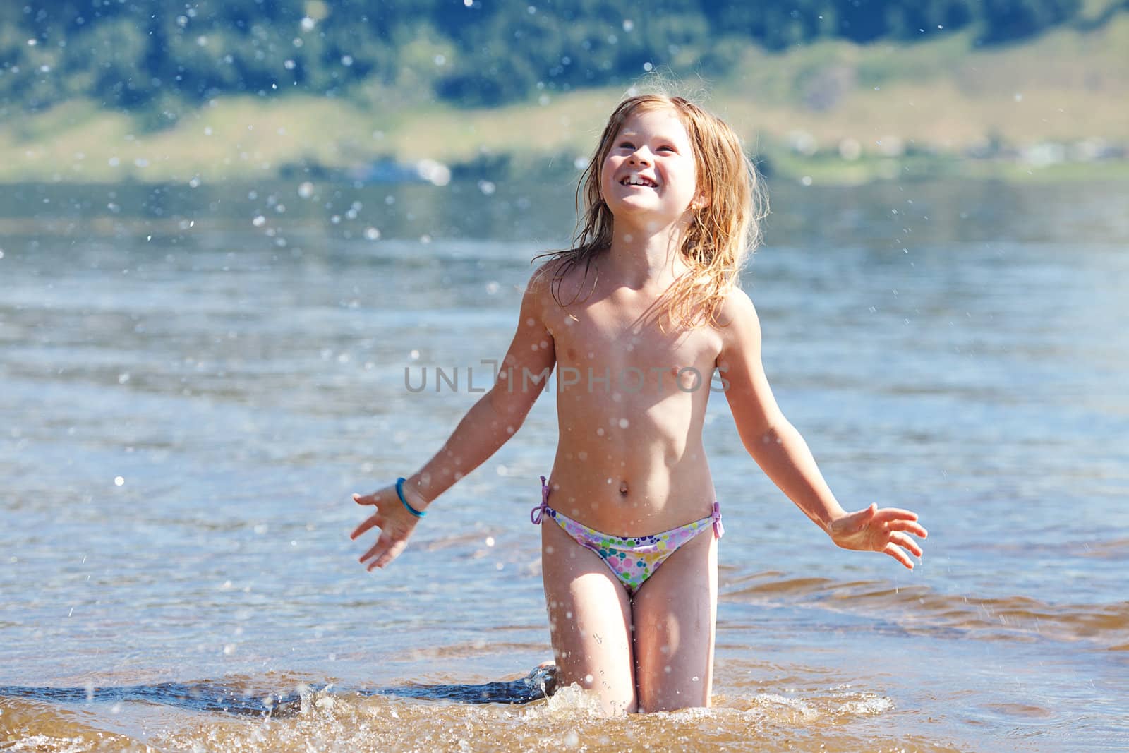 beautiful little girl splashes in the water by jannyjus