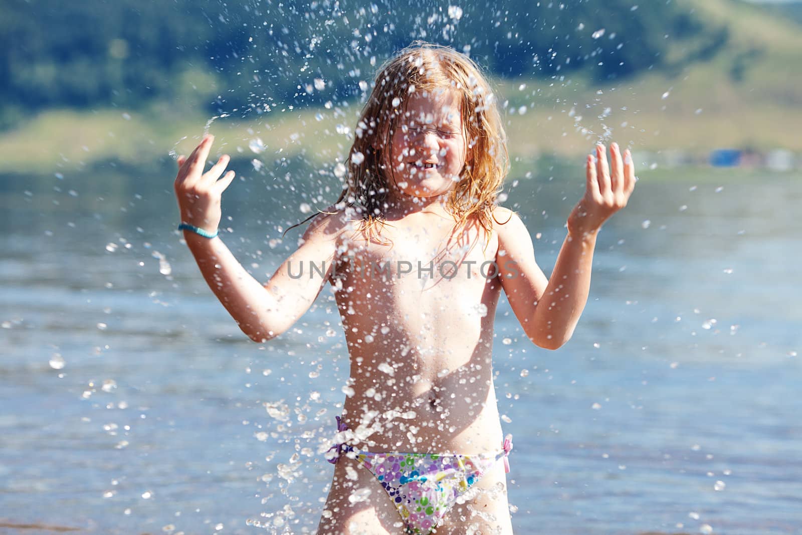 beautiful little girl splashes in the water by jannyjus