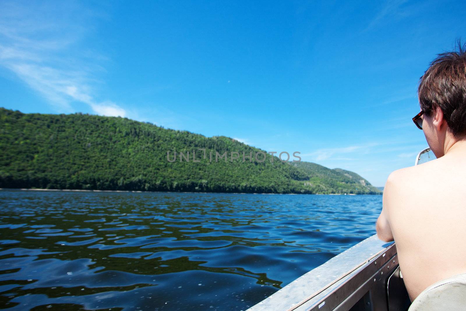 man in a boat on the background of the river and mountains by jannyjus