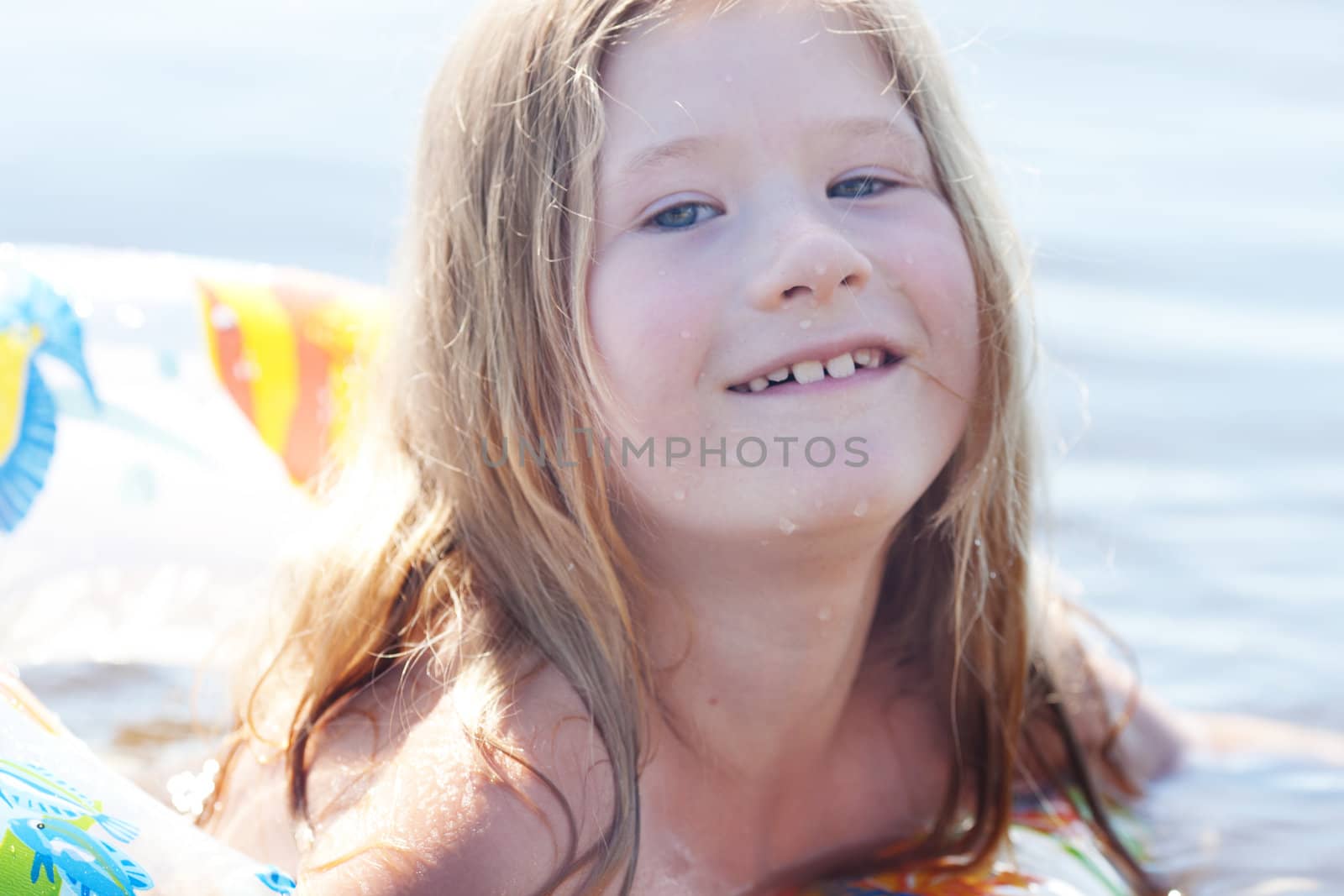 portrait of a beautiful little girl with a color lifebuoy by jannyjus