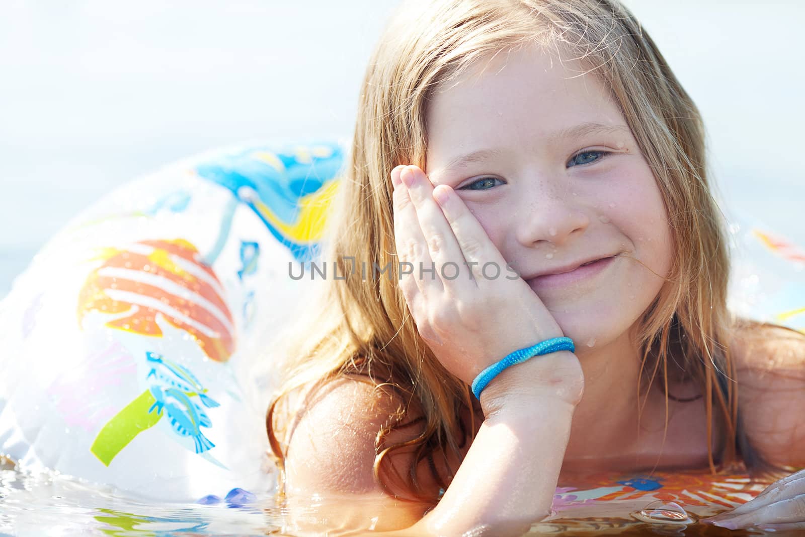 portrait of a beautiful little girl with a color lifebuoy