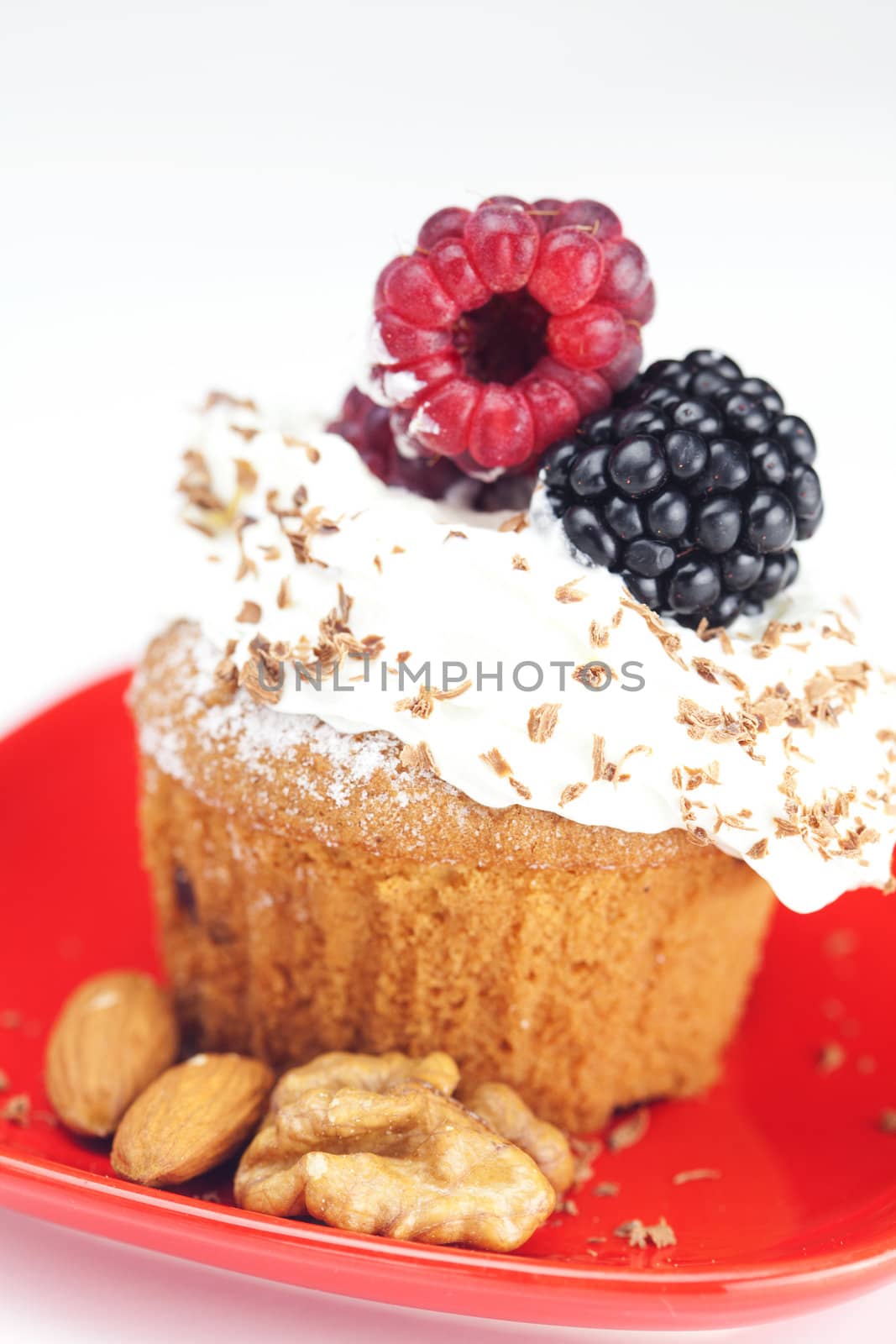 muffin with whipped cream, raspberries, blackberries and nuts