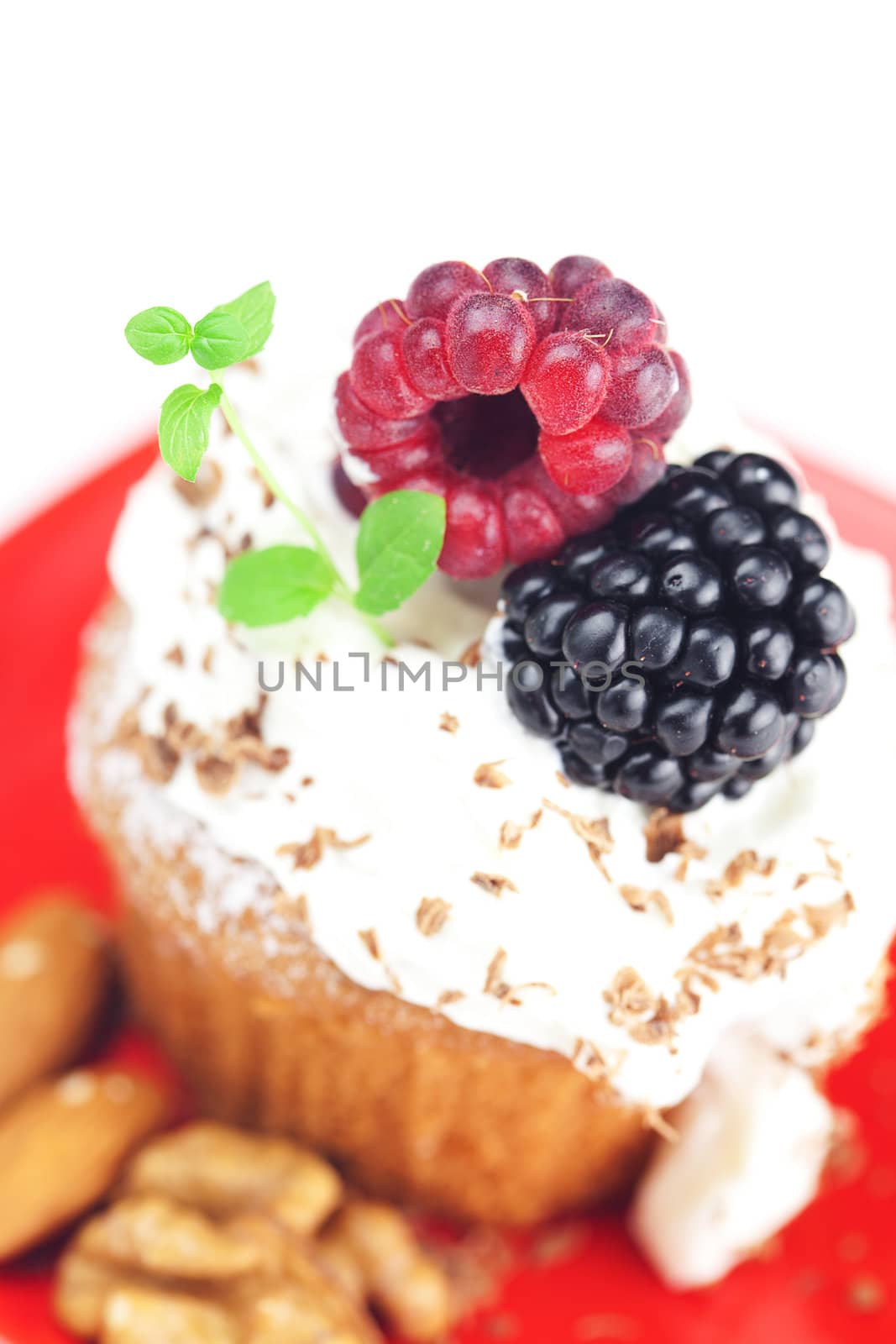 muffin with whipped cream,mint, raspberries, blackberries and nuts