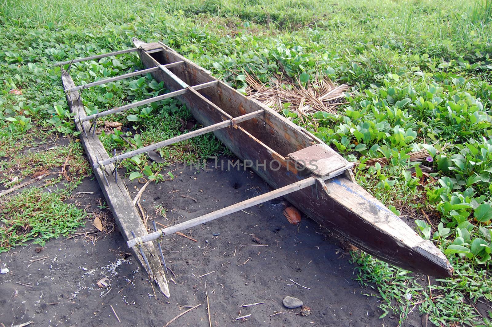 Timber canoe at beach by danemo