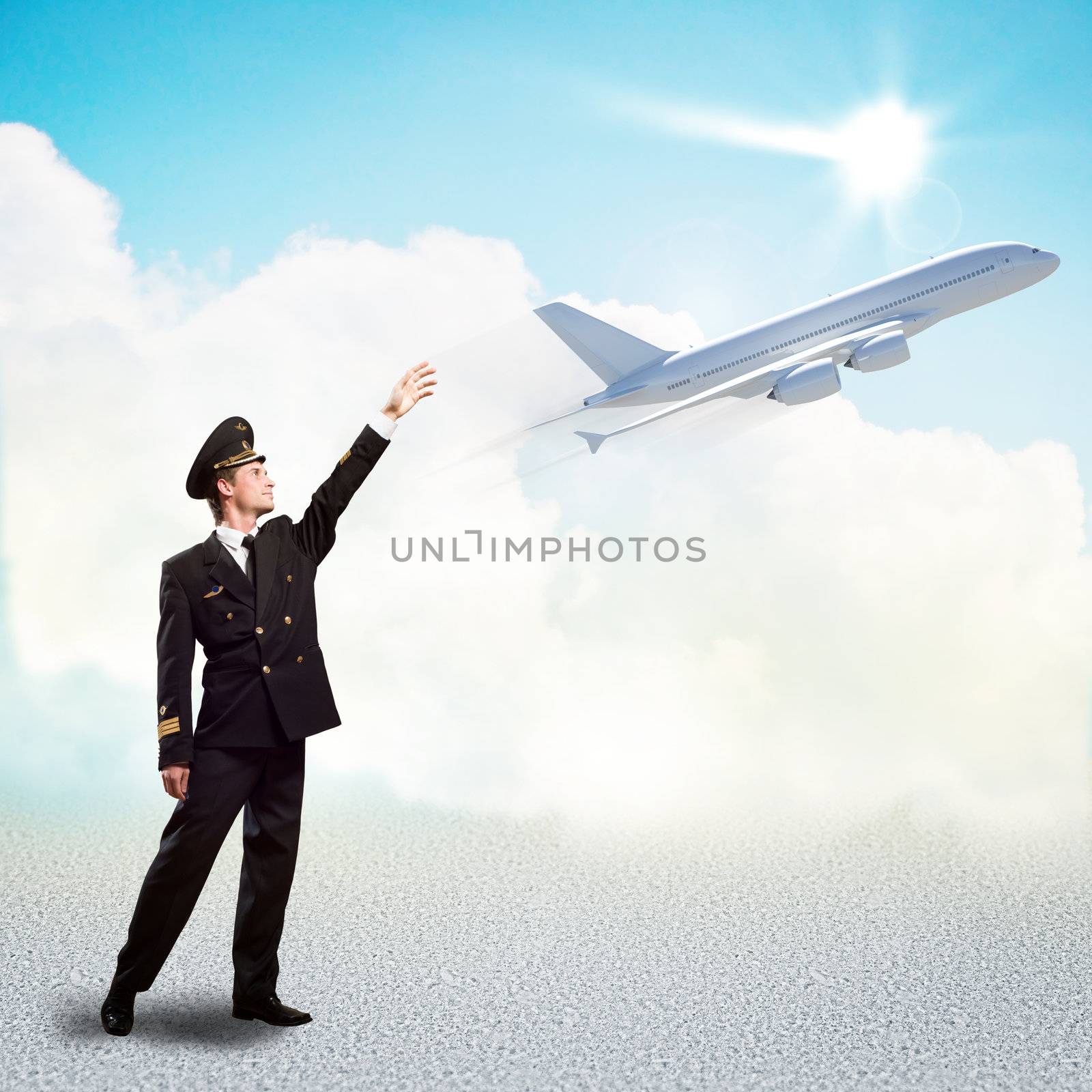 pilot in the form of extending a hand to a flying airplane on the background of clouds and sun