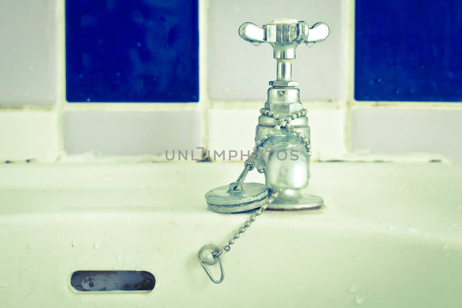 Still life image of a bathroom tap in cold tones