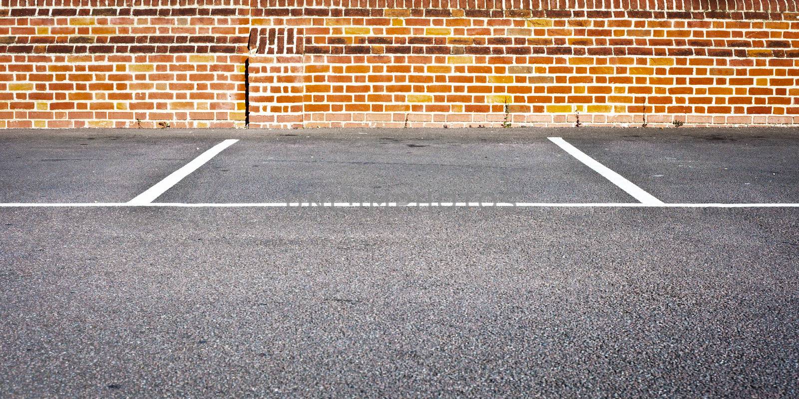 An empty car parking space in a modern parking lot