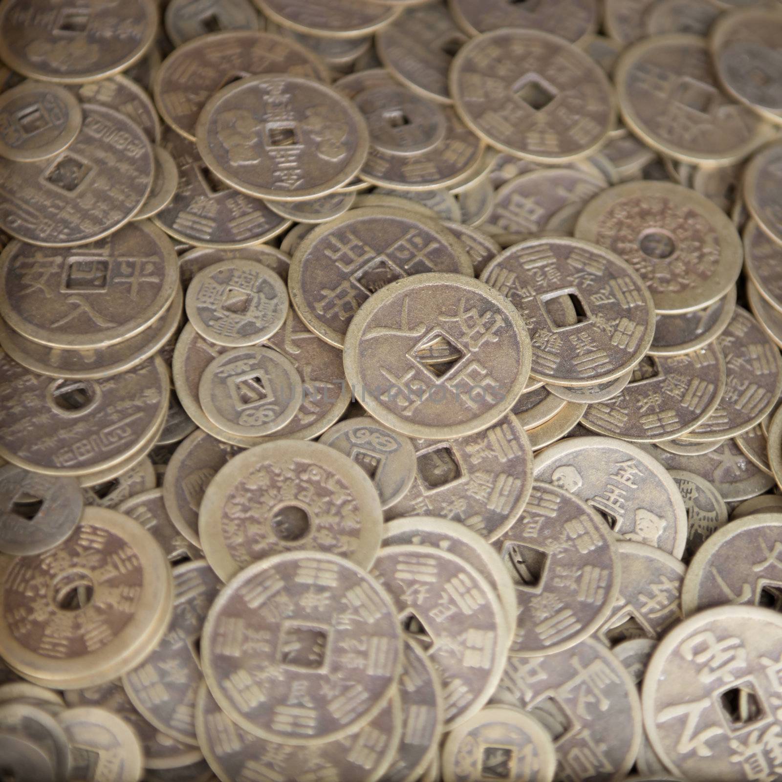 Antique bronze Chinese coins close-up background with selective focus on the middle