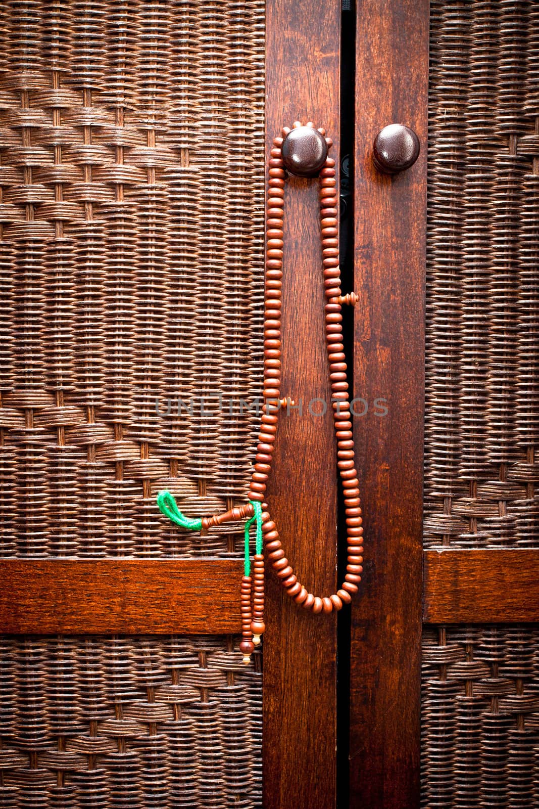 Wooden islamic prayer beads hanging on a door handle