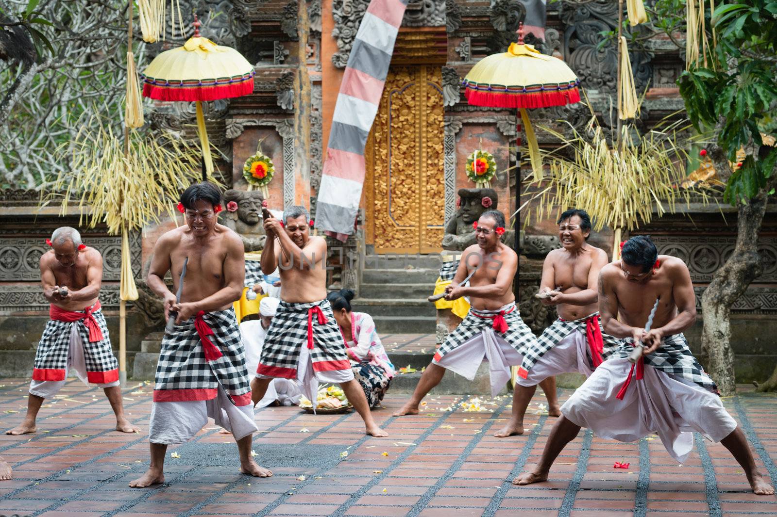 UBUD, BALI, INDONESIA - SEP 21: Kris wielding men perform ritual dance on traditional balinese Barong show on Sep 21, 2012 in Ubud, Bali, Indonesia. The show is popular tourist attraction on Bali