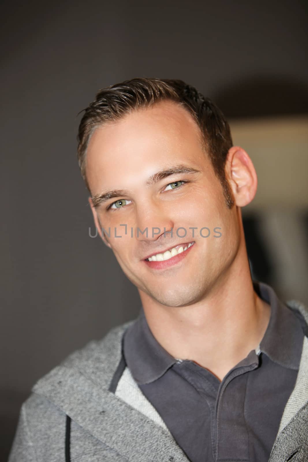 Blue eyed handsome confident Caucasian young man, looking at camera, portrait