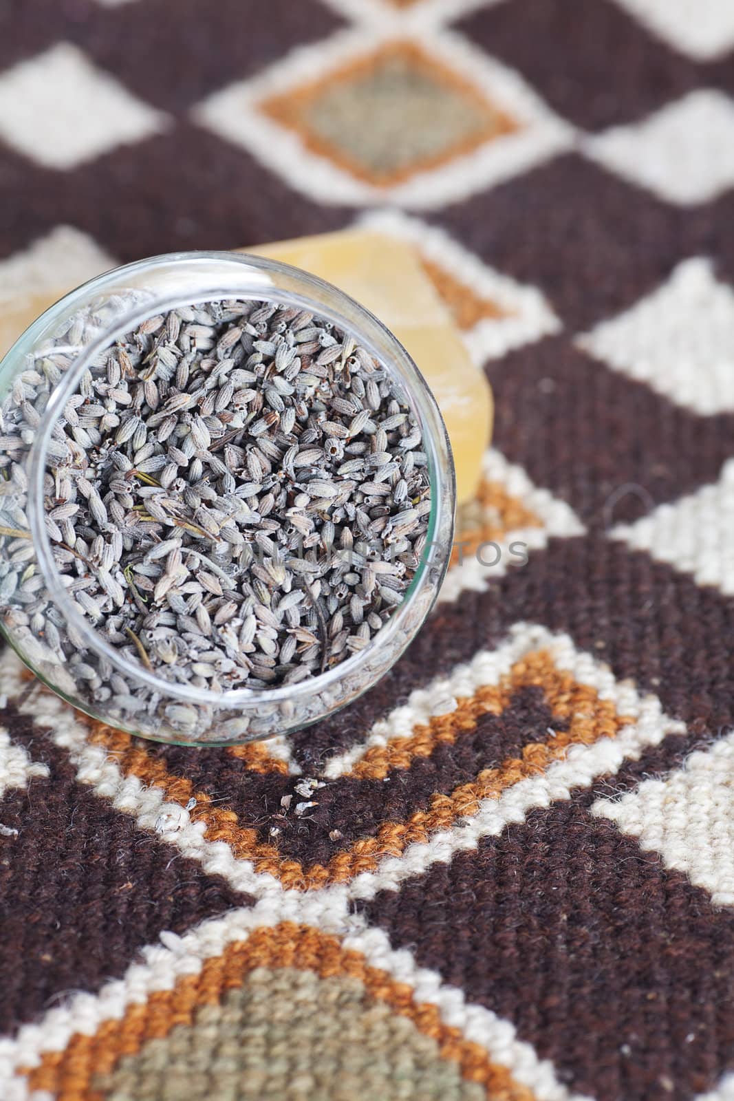 lavender in bowl and soap on ethnic mat