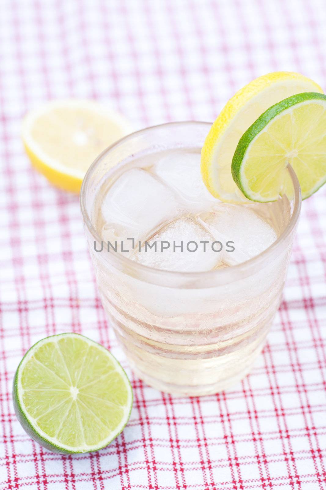 water with lemon and lime in a glass with ice