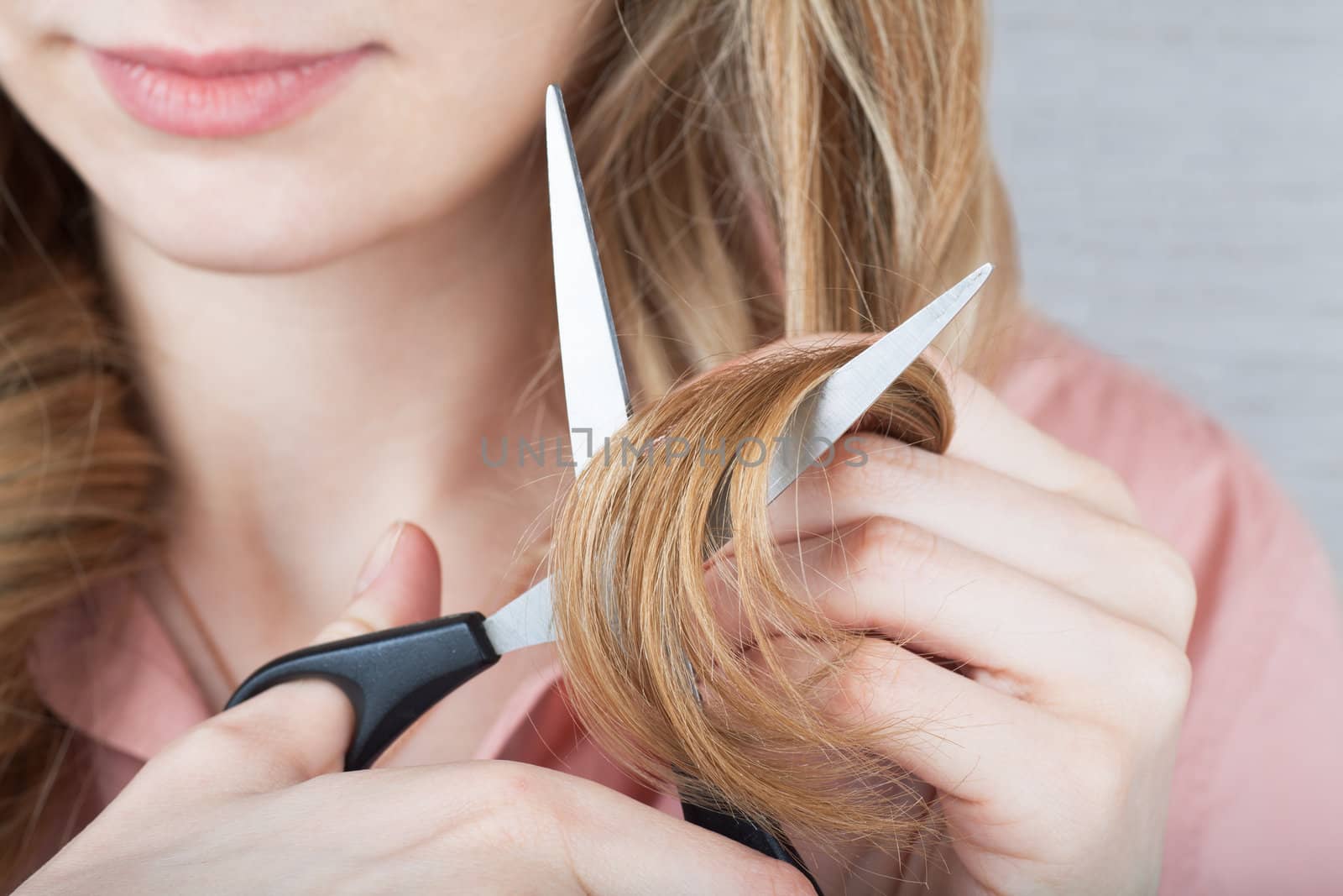 Closeup view of woman cutting her hair
