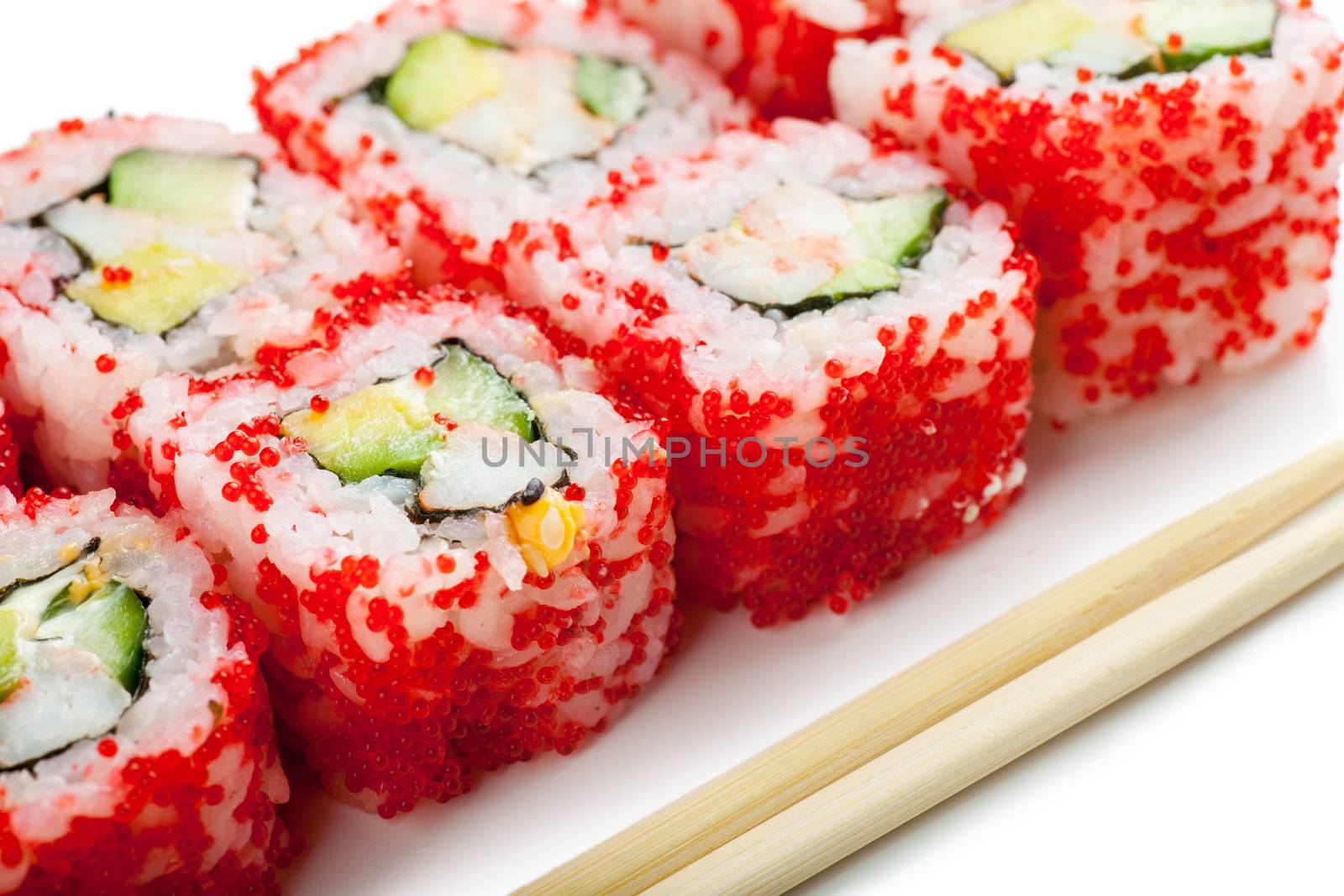 Close up top view of sushi and chopsticks over white background